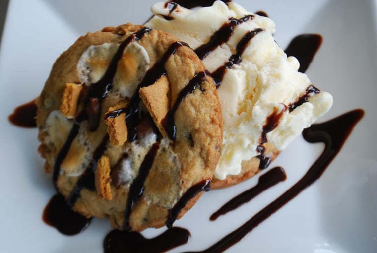 S'more Chocolate Chip Cookie served with vanilla ice cream and chocolate syrup drizzle.