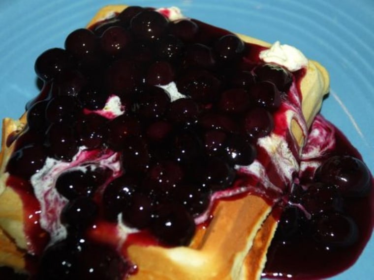 Buttermilk waffles topped with fresh blueberry compote -- you can see the butter melting.
