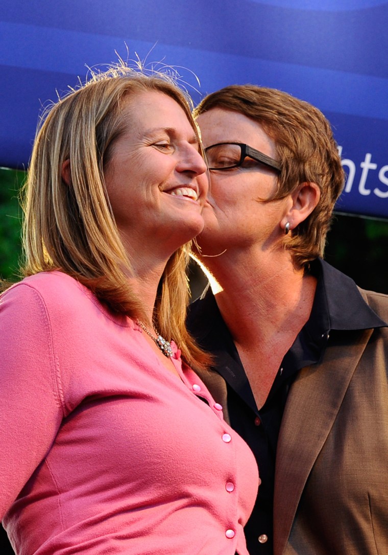Plaintiffs Kris Perry (L) kisses her partner Sandy Stier during a rally to celebrate the ruling to overturn Proposition 8 on August 4, 2010 in West Hollywood, California.