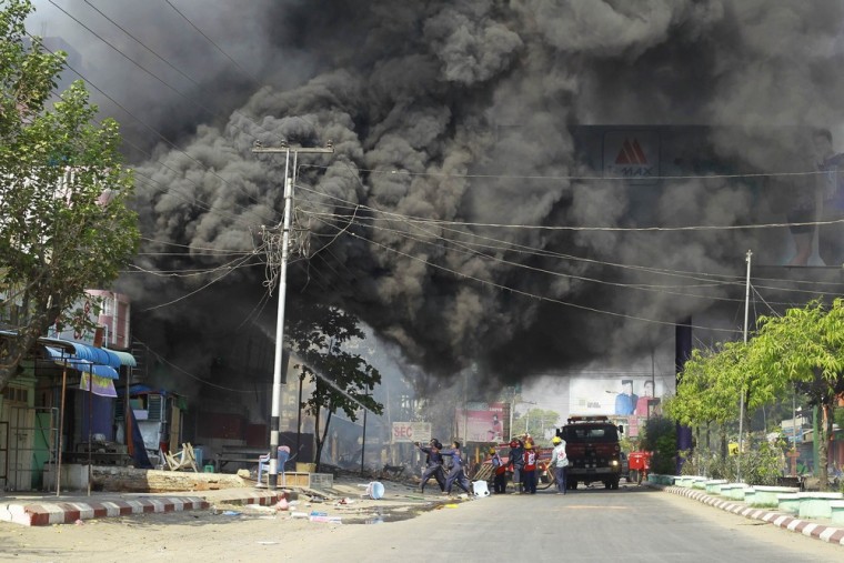 Firemen attempt to extinguish fires during riots in Meikhtila, Myanmar, on March 22, 2013. Unrest between Buddhists and Muslims in central Myanmar has reduced neighborhoods to ashes and stoked fears that last year's sectarian bloodshed is spreading into the country's heartland in a test of Asia's newest democracy.