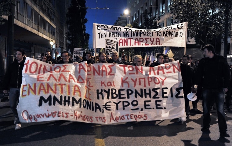 Greek leftists demonstrate on Mar. 22, 2013 in Athens in support of Cypriots with a banner, reading: