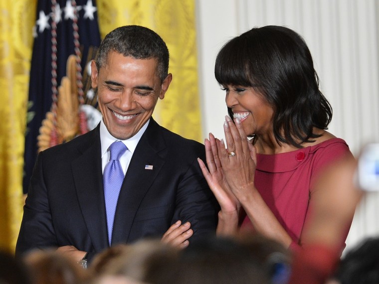President Barack Obama and First Lady Michelle Obama arrive at the Women's History Month Reception in the East Room of the White House in Washington on March 18, 2013.