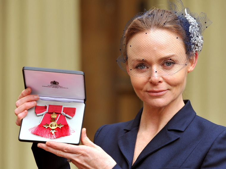 Proud moment: Stella McCartney poses holding her Officer of the British Empire (OBE) Award.