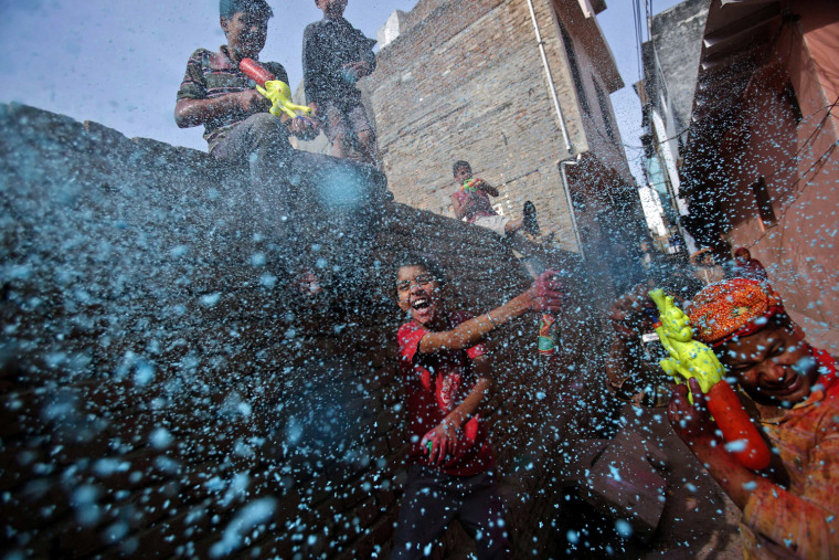 A boy sprays colored foam during Holi celebrations in a lane near the Bankey Bihari temple in Vrindavan, in the northern Indian state of Uttar Pradesh on March 26. Holi, also known as the Festival of Colours, heralds the beginning of spring and is celebrated all over India.