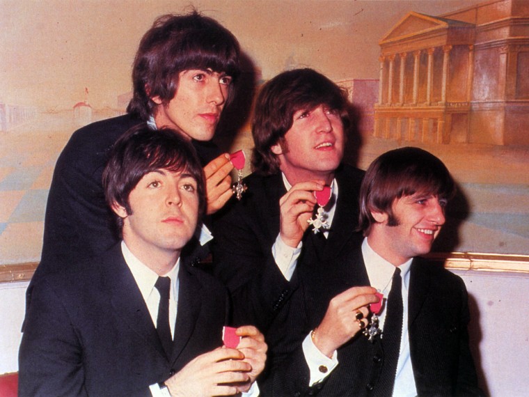 The Beatles (Paul McCartney, George Harrison, John Lennon and Ringo Starr)  show the medals making them members of the Order of the British Empire, presented to them by the Queen at Buckingham Palace on October 26, 1965.