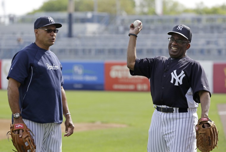 Hall of famer and New York Yankees special adviser Reggie Jackson, left, watches as Al warms up.