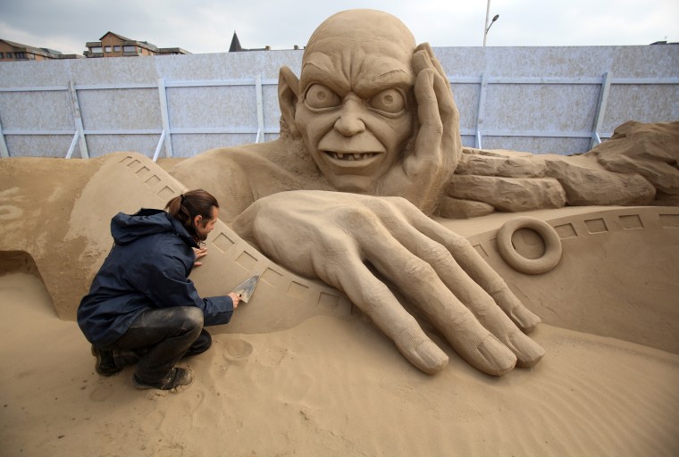 Sand sculptor Radavan Zivny works on a sculpture of Gollum.