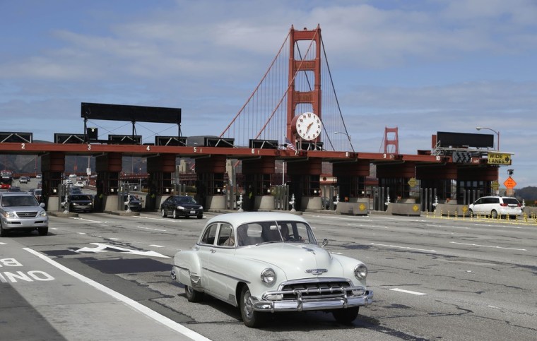 An old Chevrolet makes its way past the toll booths on Tuesday.