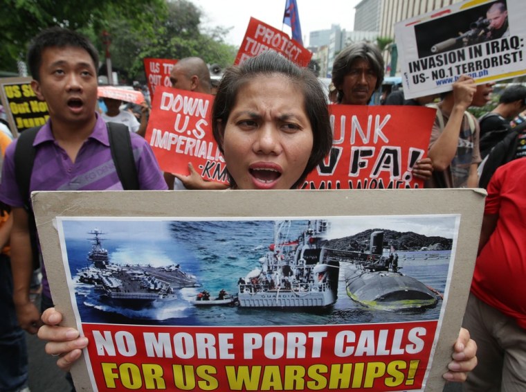 March 18: Filipino protesters shout slogans during a rally near the U.S. Embassy in Manila in protest at the alleged destruction of the coral reef by the USS Guardian.