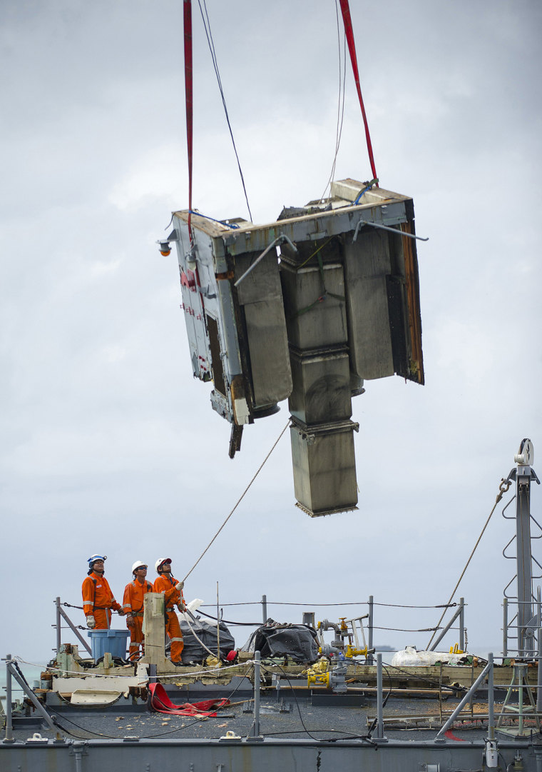 March 9: Contractors remove an exhaust pipe section.