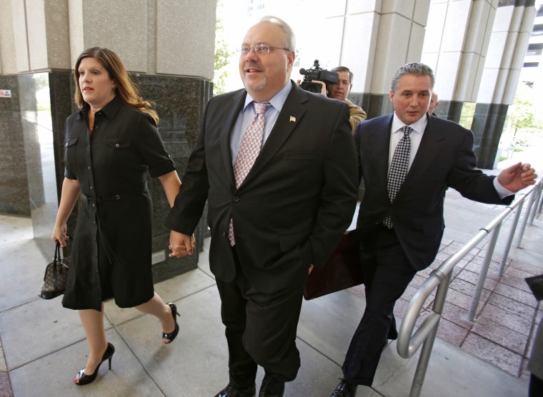 Former Florida GOP chairman Jim Greer, center, arrives at the Orange County Courthouse, with his wife Lisa, left, and attorney Damon Chase, right, for a sentencing hearing, Wednesday, March 27, in Orlando, Fla.