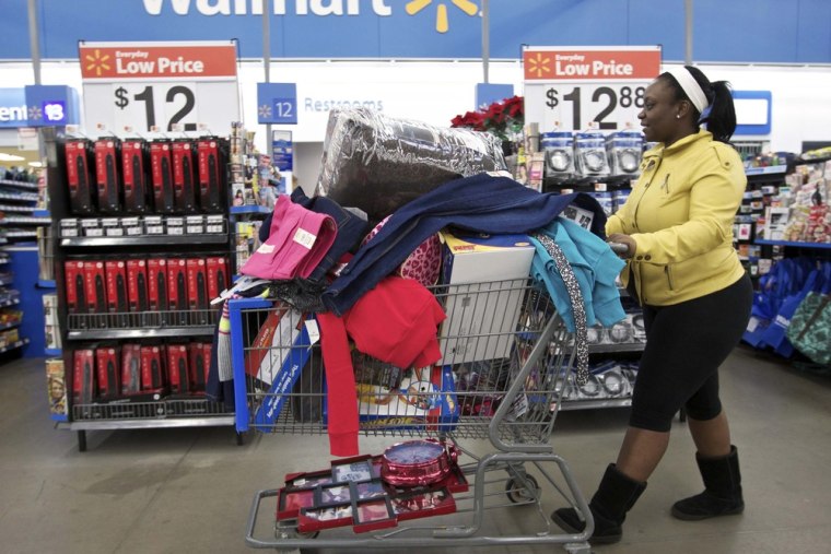 A woman with a full shopping cart heads to the checkout at a Wal-Mart Store in Chicago in this file photo taken November 23, 2012.