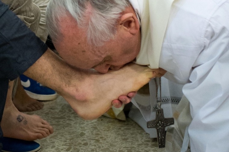 Pope Francis kisses the feet of a young offender after washing them during a mass at the church of the Casal del Marmo youth prison on the outskirts of Rome.