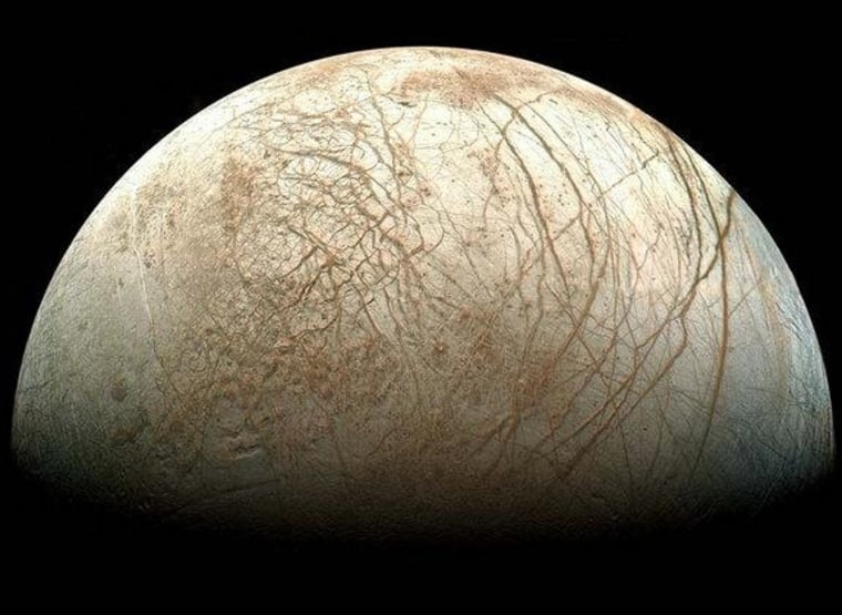 Europa, as viewed from NASA's Galileo spacecraft. Visible are plains of bright ice, cracks that run to the horizon, and dark patches that likely contain both ice and dirt.