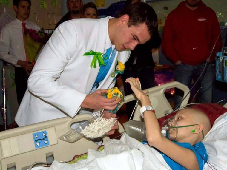 Katelyn's prom date, Children's Hospital Volunteer Jacob, puts Katelyn's corsage on. No one wanted her to miss prom.