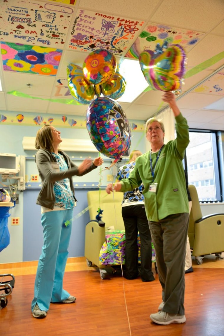 Volunteers and nurses helping friends and family set the stage for Katelyn's prom.