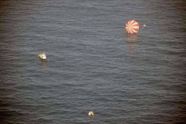 Recovery boats approach Dragon after splashdown into the Pacific Ocean on March 26, 2013. Dragon returned from the International Space Station.