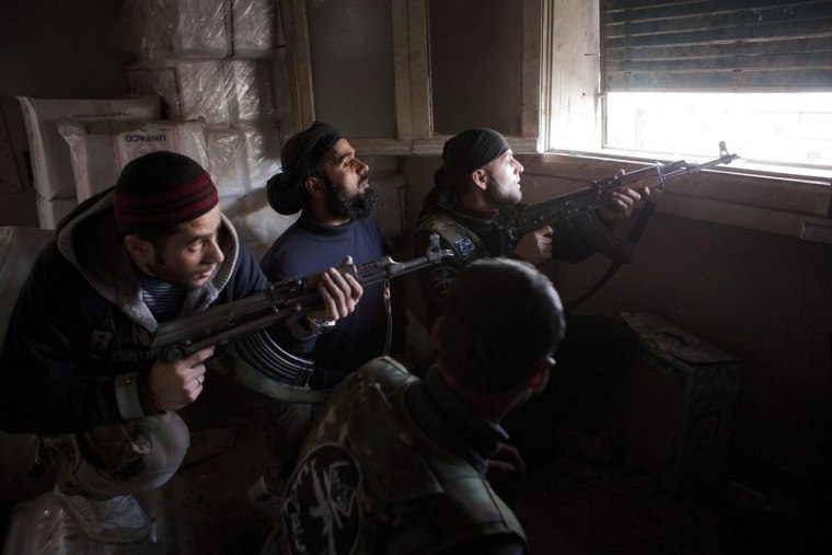 Syrian Army fighters preparing themselves to shoot against Syrian Army positions in Aleppo, Syria, March 11.