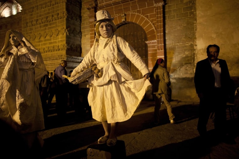 Living statues perform in front of a church as part of the Holy Week celebrations in Ayacucho.