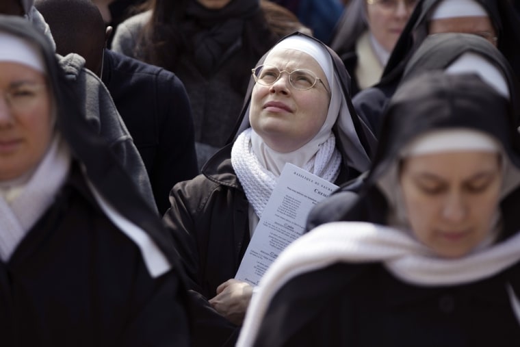 Nuns take part in a Way of the Cross to celebrate Good Friday, in front of the Sacre-Coeur Basilica in Montmartre district, in Paris, on March 29, 2013.