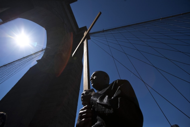 Frank Simmonds, of the Bay Ridge neighborhood of Brooklyn, carries a cross on the Brooklyn Bridge during the 18th annual 'Way of the Cross Over the Brooklyn Bridge Ceremony' in New York March 29, 2013. The ceremony, hosted yearly on the Christian holy day of Good Friday, includes walking from St. James Cathedral, over the Brooklyn Bridge to St. Peter's Church, in Manhattan. The event attracts approximately 2,000 people each year.
