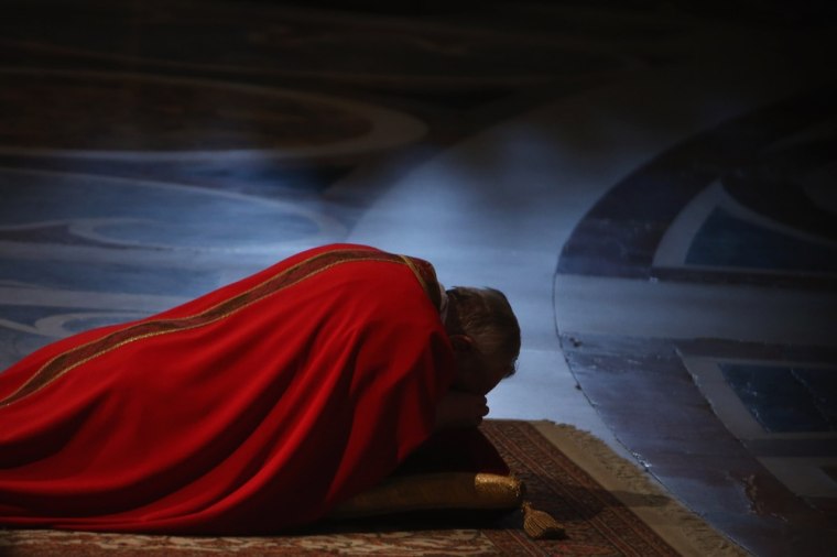 Pope Francis prays on the floor during a Papal Mass with the Celebration of the Lord's Passion inside St Peter's Basilica on March 29, 2013 in Vatican City, Vatican. Pope Francis is taking part in his first holy week as pontiff and will later today preside over the Way Of the Cross procession at the Colosseum in Rome.