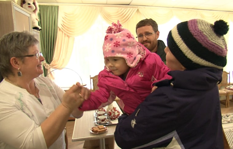 Russian child psychologist Valentina Rakova Valentina (left) stands with Kristina and Richard England and newly adopted Sonia in an orphanage in Bryansk, rural Russia.