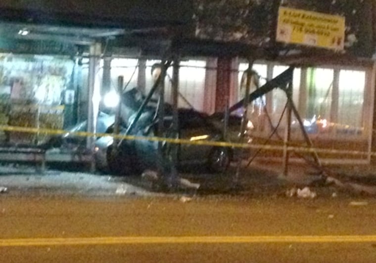 A car rests in the middle of mangled scaffolding after jumping a curb Saturday in Brooklyn.