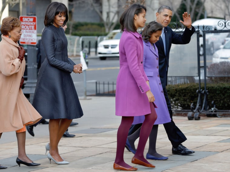 President Barack Obama, accompanied by his daughters Sasha and Malia, first lady Michelle Obama and mother-in-law Marian Robinson, waves as they arriv...