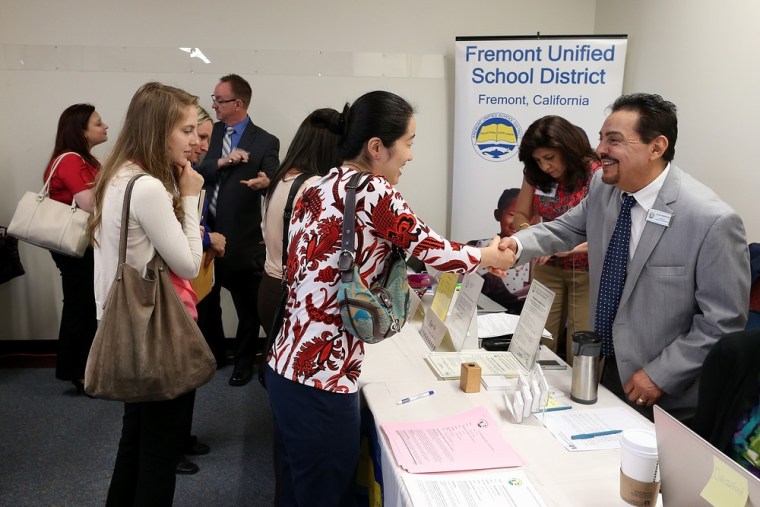 Job seekers meet with a recruiter for the Fremont Unified School District during a job fair at the Alameda County Office of Education on April 24, 201...