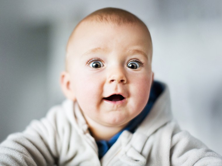 Portrait of baby with funny, surprised expression