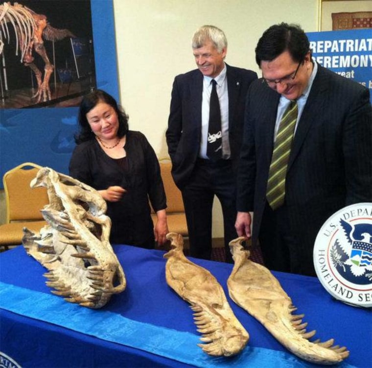 Before a repatriation ceremony to return dinosaur fossils to Mongolia, three people involved in the case, paleontologists Bolortsetseg Minjin and Philip Currie, and attorney Robert Painter, posed with the fossils.