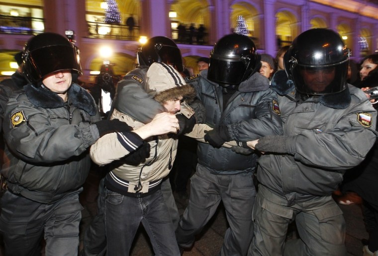 Police in St. Petersburg, Russia, detain an opposition activist during a Wednesday protest against recent election results.