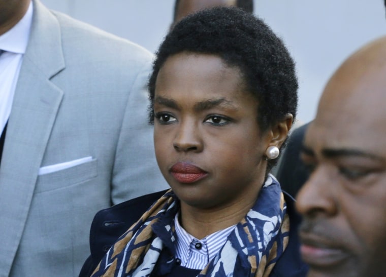 Eight-time Grammy Award winning singer Lauryn Hill, center, leaves federal court in Newark, N.J., Monday, May 6, 2013, after sentencing in her tax eva...
