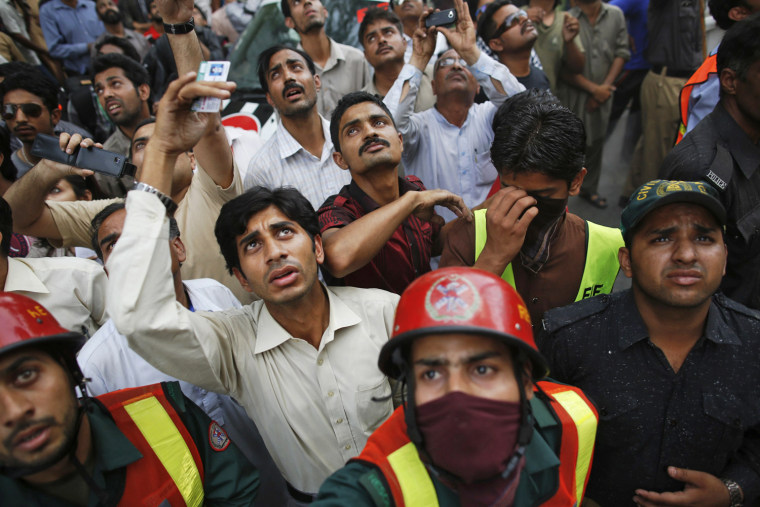 Rescue workers save people from a building fire in Pakistan