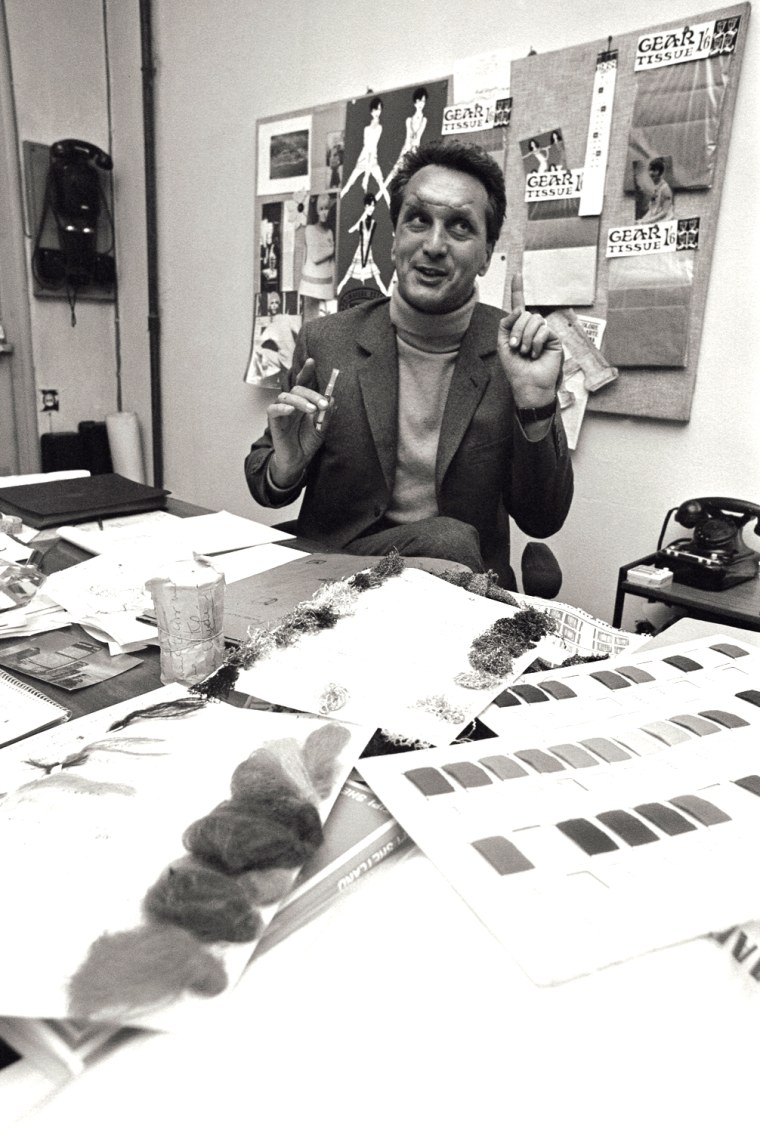 Fashion designer Ottavio Missoni, sitting at his desk in his study, full of sketches and sheets in Italy, 1968.