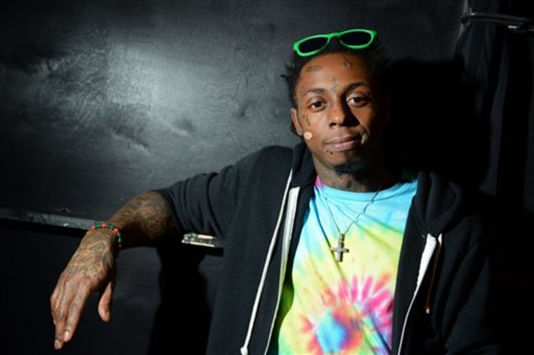 FILE - In this Feb. 1, 2013 file photo, recording artist Lil Wayne meets fans and celebrates his contemporary street wear apparel brand TRUKFIT at his...
