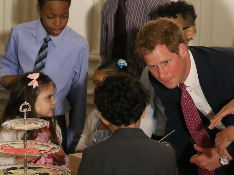 WASHINGTON, DC - MAY 09:  Prince Harry talks to young children during an event hosted by first Lady Michelle Obama to honor military families at the W...