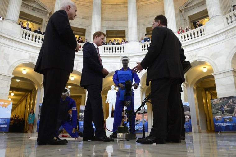 WASHINGTON, DC - MAY 09:  Prince Harry (2-L) is shown a ground penetrating radar, a tool used for detecting land mines, during tour of a HALO Trust ph...