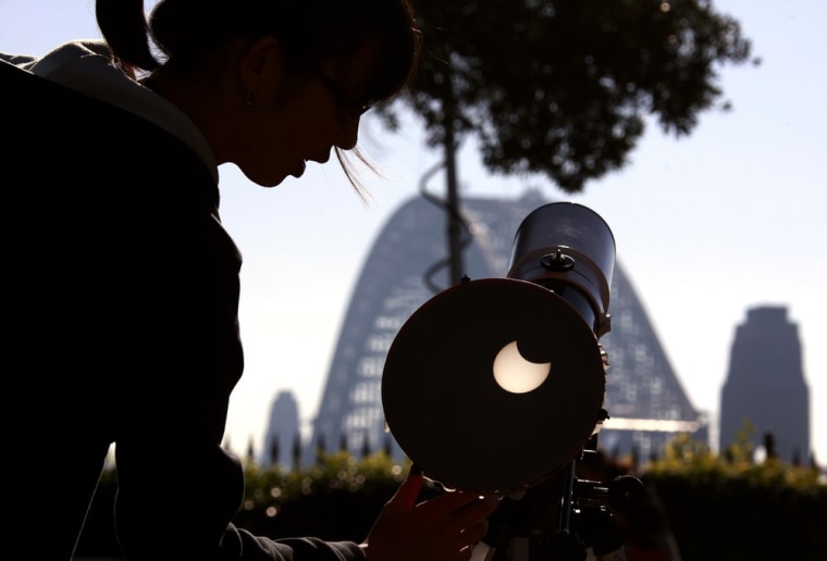 A telescope set up on Sydney's Observatory hill projects an image of the partial solar eclipse onto a screen.