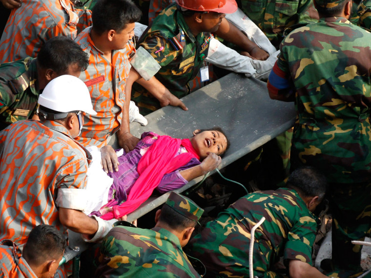 Rescuers pull out a female survivor, Reshma, alive on the 17th day after the Rana Plaza building collapsed, in Savar, Dhaka, Bangladesh, 10 May 2013. Television footage showed troops removing the survivor, identified as Reshma Begum, from the rubble and taking her to an ambulance.