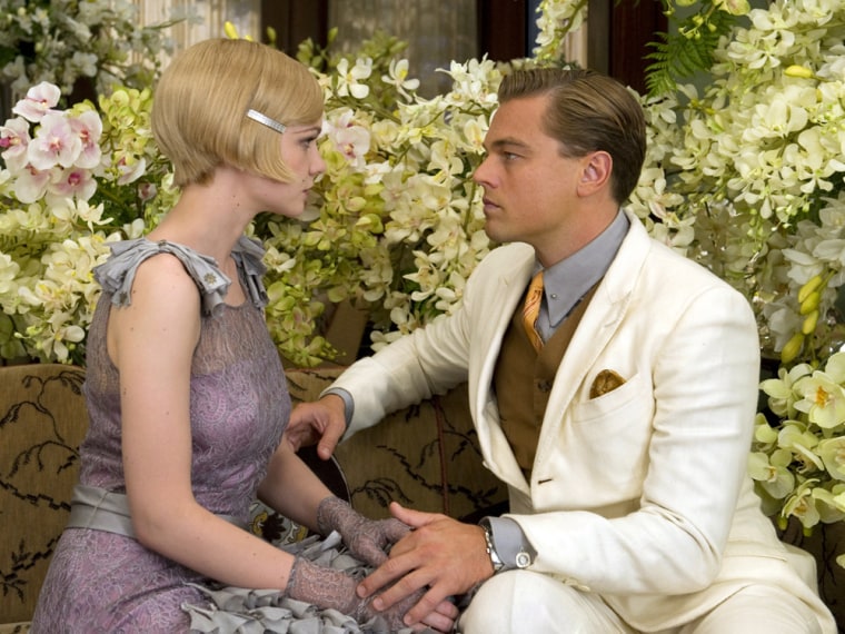 This film publicity image released by Warner Bros. Pictures shows Carey Mulligan as Daisy Buchanan, left, and Leonardo DiCaprio as Jay Gatsby in a sce...
