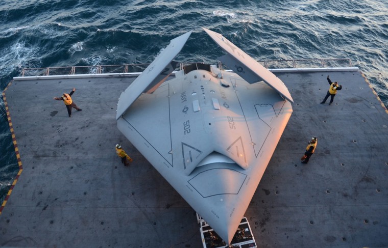 Sailors move an X-47B Unmanned Combat Air System (UCAS) demonstrator onto an aircraft elevator aboard the aircraft carrier USS George H.W. Bush at an unspecified location in the Atlantic Ocean, on May 14.