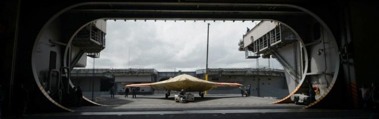 An X-47B Unmanned Combat Air System demonstrator sits on an aircraft elevator on the aircraft carrier USS George H.W. Bush on May 6.