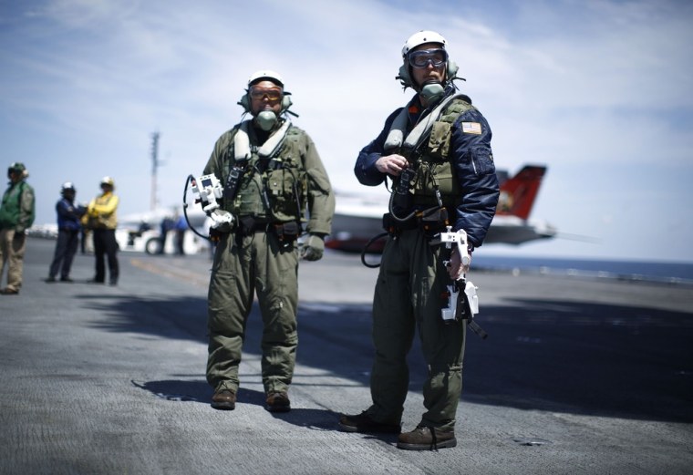 Northrop Grumman test pilots Bruce McFadden, left, and Dave Lorenz are pictured with their arm-mounted controllers after they successfully launched an X-47B pilot-less drone combat aircraft for the first time off an aircraft carrier in the Atlantic Ocean off the coast of Virginia, on May 14.