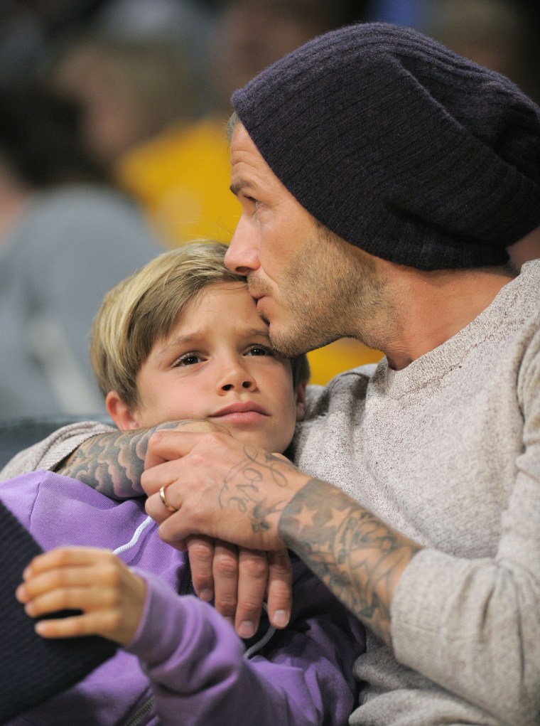 David has no problem being affectionate with his son, Romeo, at a Lakers game in Los Angeles.