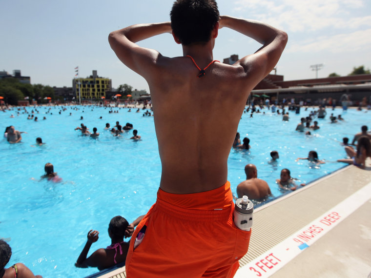 A lifeguard keeps watch on opening day of the McCarren Park Pool, June, 2012 in Brooklyn. CDC researchers found evidence of feces in many US pools.