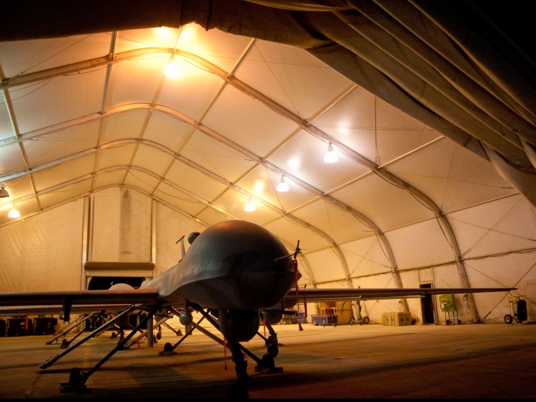 MQ-1B Predator unmanned aerial vehicles sit in a clamshell at night at Kandahar Airfield, Afghanistan, July 31, 2011.