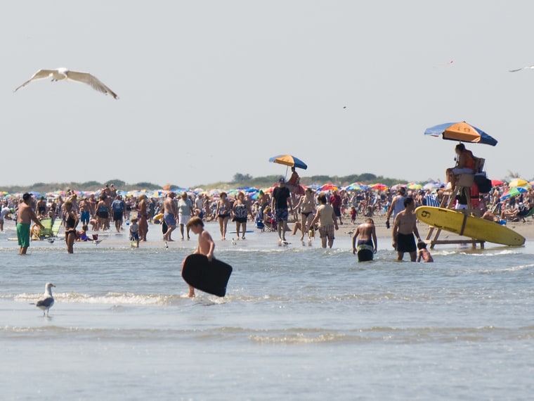 Tourists enjoying the water at the Jersey Shore.