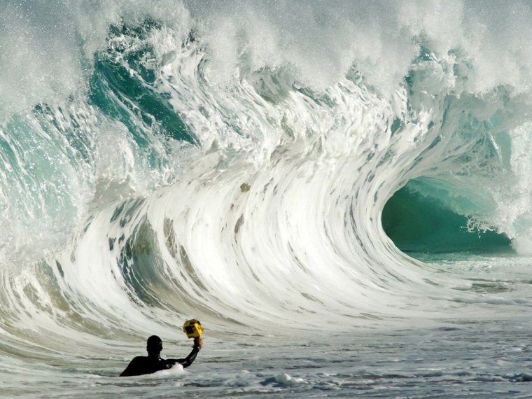 Clark Little braves a big wave to get the perfect shot.